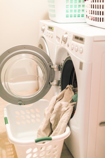 Doing laundry in laundry room of modern single family house in suburbs.