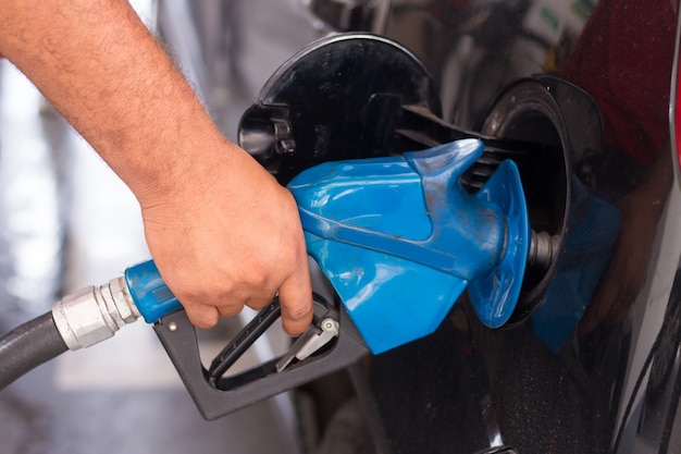 Doing supply with gasoline in vehicle in fuel station