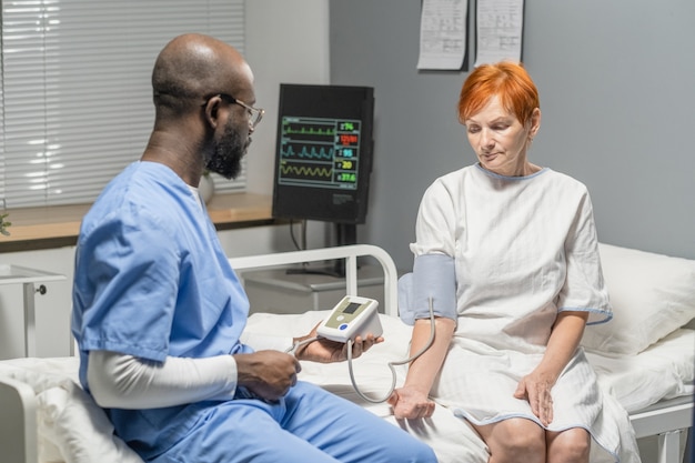 Dokter die de druk van de patiënt meet