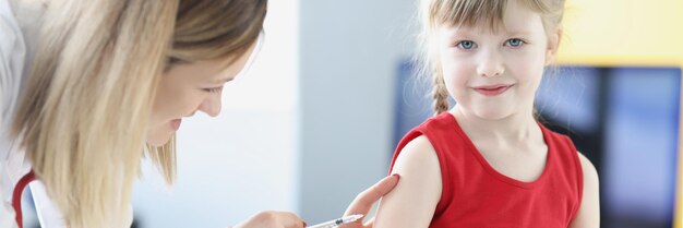 Foto dokter injecteert klein meisje in vaccinatieconcept voor schouder