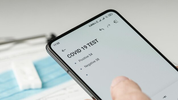 Dokter schrijft resultaten van covid-uitstrijkje op smartphone