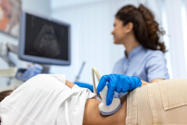 Foto dokter voert echo-onderzoek uit van de nieren van de patiënt interne organen echo-concept vrouwen onderste rug diagnose uitgevoerd met behulp van een echo