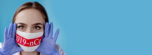 Dokter vrouw met chirurgisch masker wijzend naar rood papier met bericht Coronavirus op blauwe achtergrond Wereldgezondheidsorganisatie WHO introduceerde nieuwe officiële naam voor de ziekte van Coronavirus genaamd COVID19