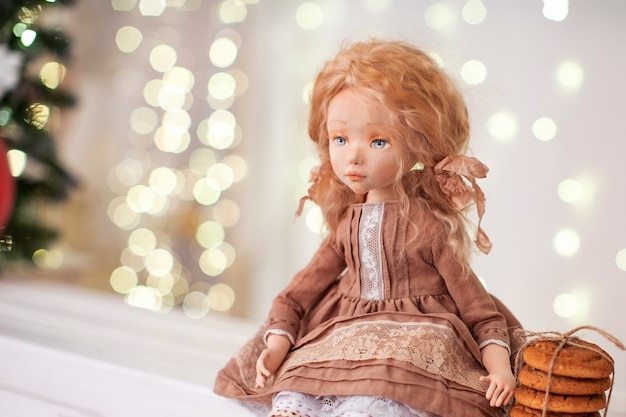 Doll in dress near the Christmas tree