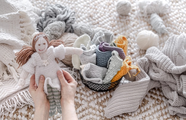 A doll made of knitted elements, threads and yarn.