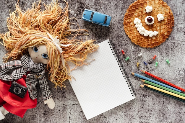 Doll, school supplies and waffle with whipped cream