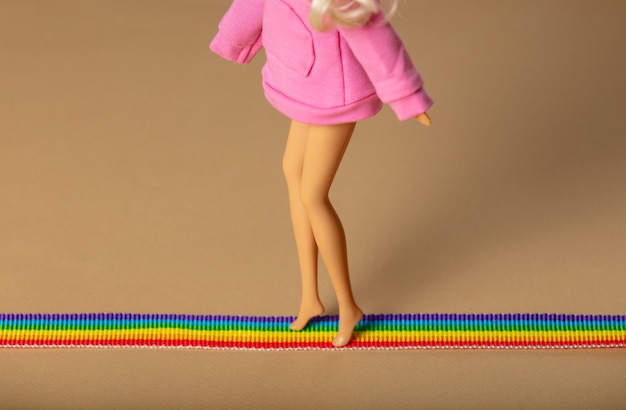 Doll walking on LGBT rainbow strip