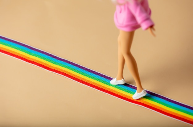 Doll walking on LGBT rainbow strip