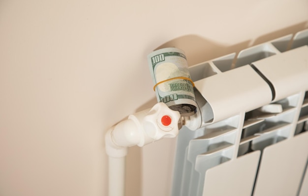 Dollar banknote on a heating radiator