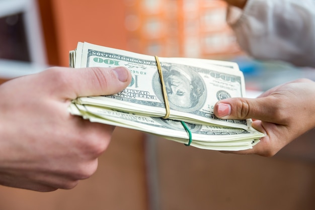 Photo dollar banknotes in bunch with human hands