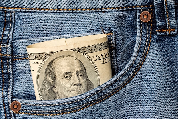 Dollar banknotes in jeans pocket