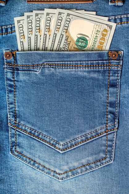 Dollar banknotes in jeans pocket