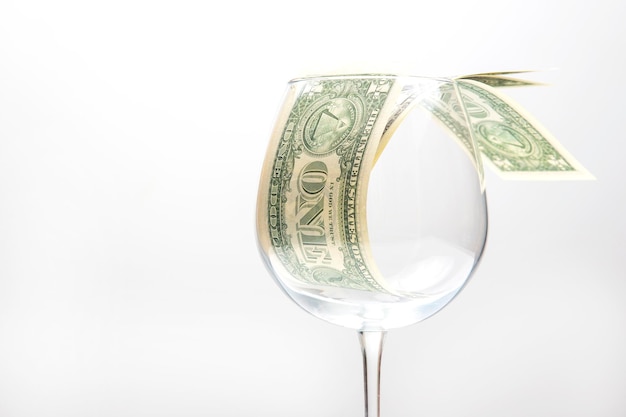 Dollar banknotes money lies in an empty wine glass business in the wine industry alcohol marketing