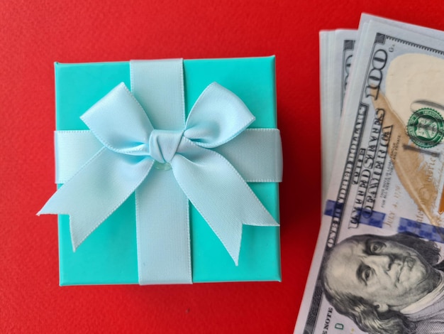 Photo dollar banknotes and surprise gift box closeup