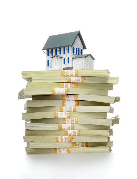 Dollar bills and house model on light background