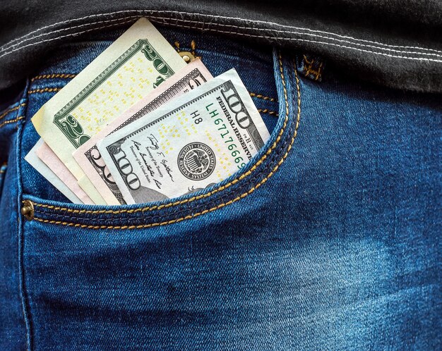 Dollar bills in men's jeans pocket