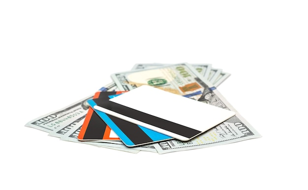 Dollar bills with credit cards on white