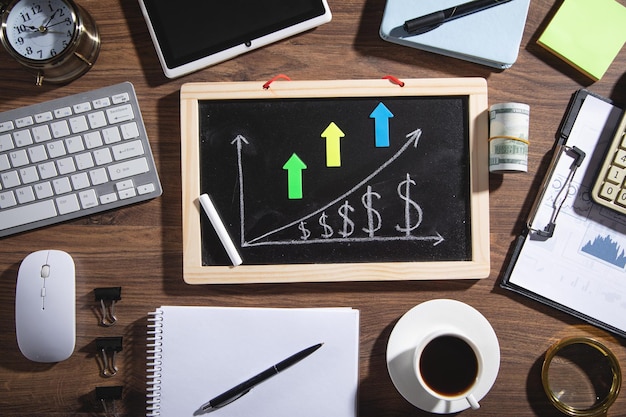 Dollar growth chart on blackboard with a business objects