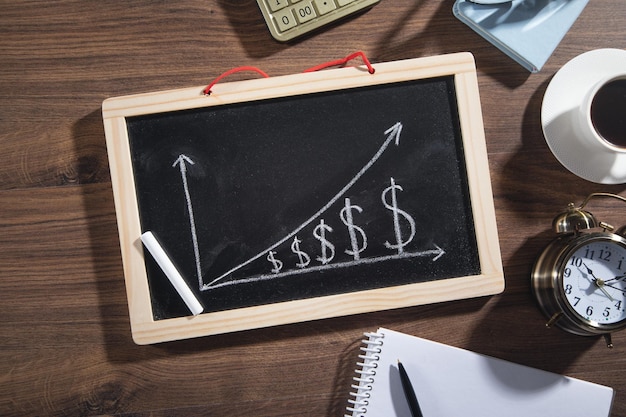 Dollar growth chart on blackboard with a business objects