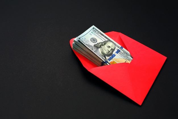 Photo dollar money in the red envelope on black