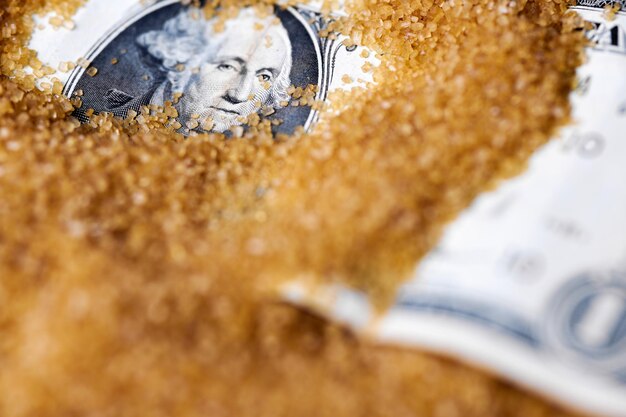 Dollar money in sugar sugar export prices concept american dollar in scattering powdered sugar