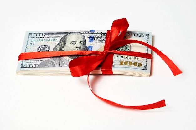 Dollar money with red ribbon on white background with copy space. Money gift