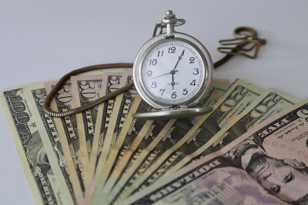 Dollar and old clock Selective Focus