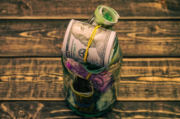 Dollars and euros in a glass jar.