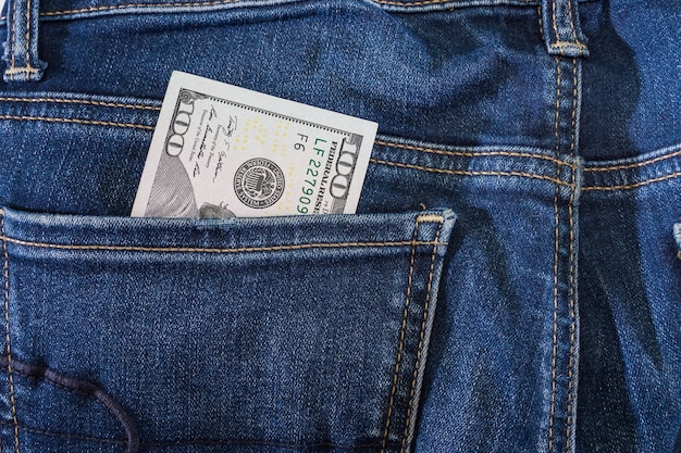 Dollars in jeans pocket. Close-up.