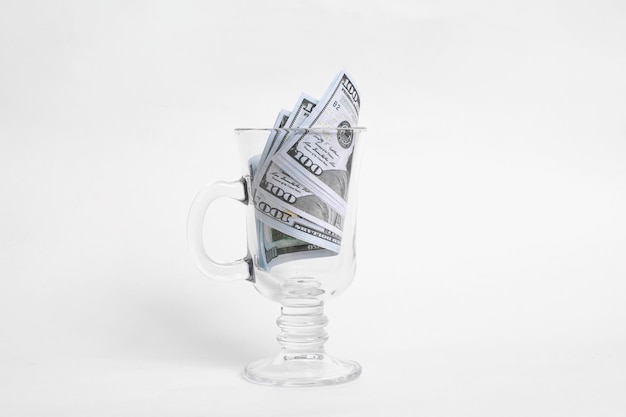 Dollars in a mug on white background