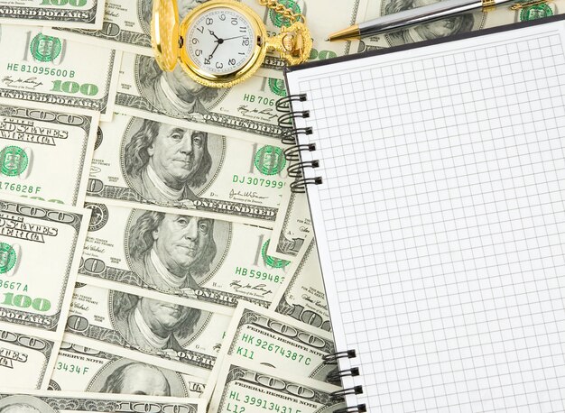 Dollars, notebook with gold watch and pen