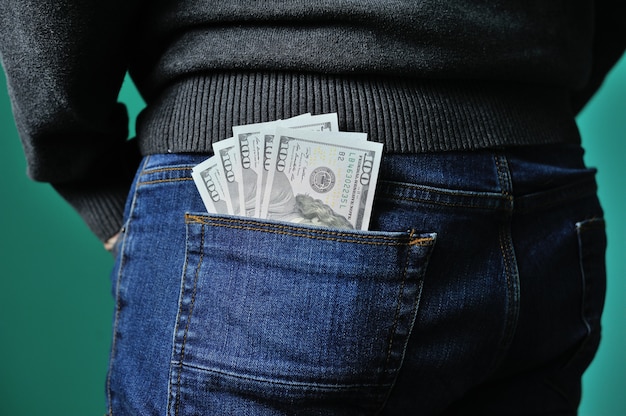 Dollars in the pocket of jeans Bundle of dollars Money in the pocket of trousers