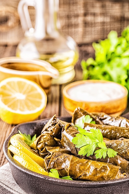 Dolma, stuffed grape leaves with rice and meat on dark background, selective focus.