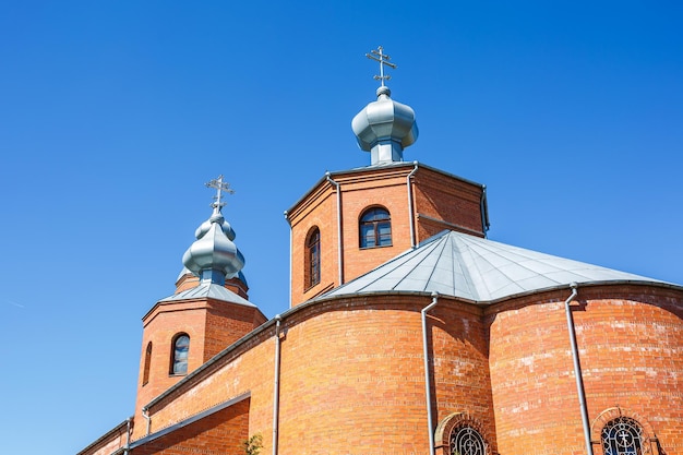 Dome of Orthodox Christian Church of red brick in summer sunny day