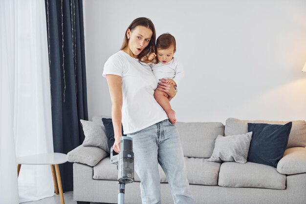 Domestic life Mother with her little daughter is indoors at home together