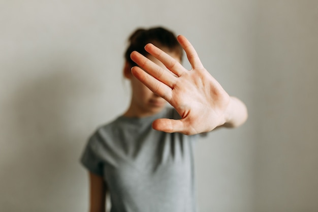 Domestic violence against women The girl covers her face with her hand and asks for help