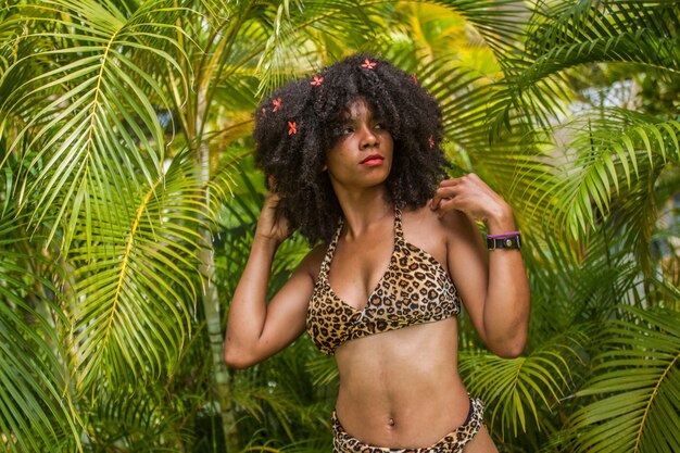 Dominican girl dressed as a Taino surrounded by green tropical forest