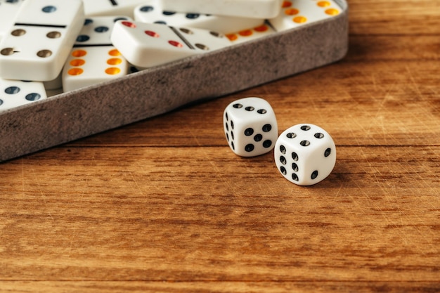 Domino game on brown wooden background close up