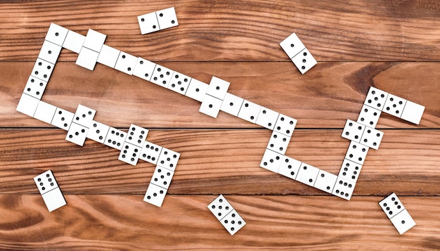 Domino game on the wooden table Top view