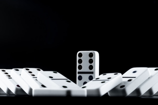 Photo domino pieces put in a row on black surface