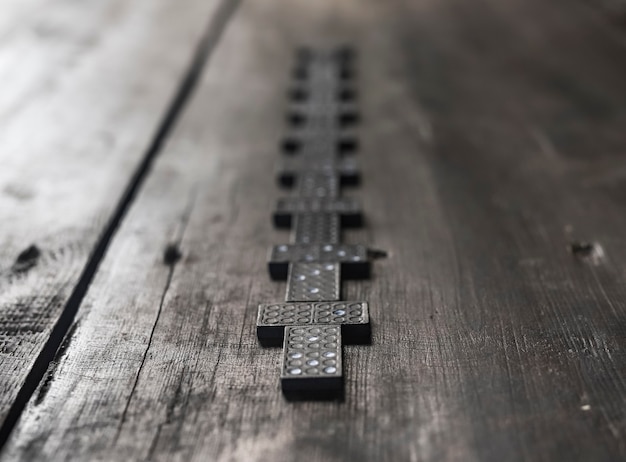 Domino pieces on wood table concept of way forward in blurred\
unpredictable future