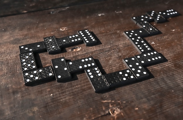 Domino pieces on wood table in order of game concept of way