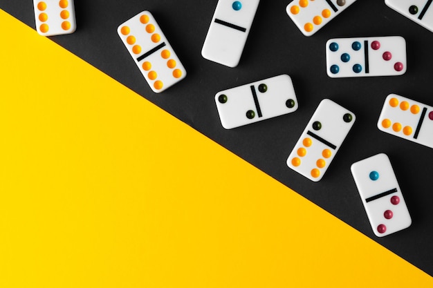 Domino tiles on black and yellow background