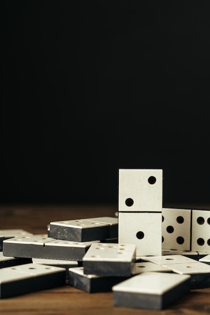 Domino tiles on wooden background close up