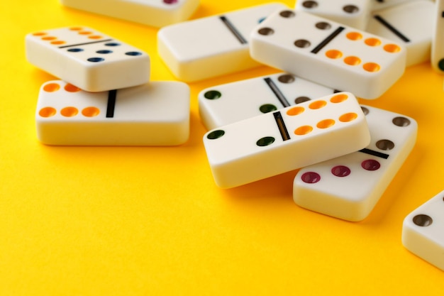 Domino tiles on yellow background studio shot