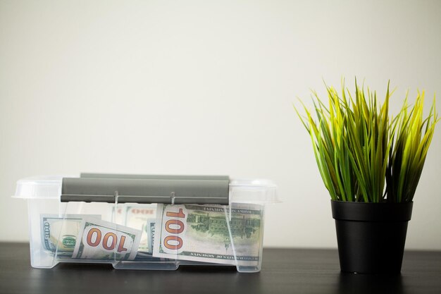 Donate box with dollars on wood desk