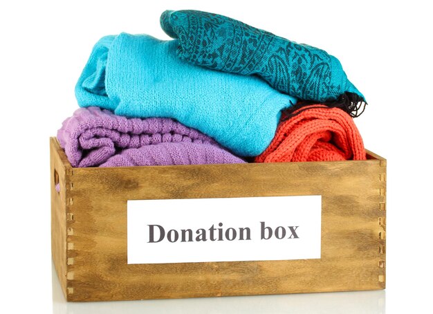 Donation box with clothing isolated on white