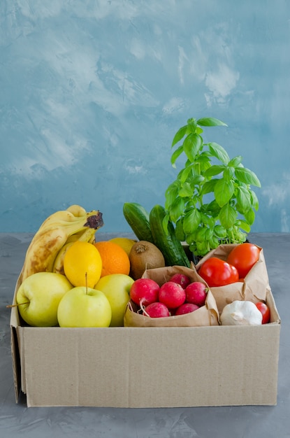 Donation box with fresh organic fruits, vegetables and herbs. Delivery healthy food to the home.