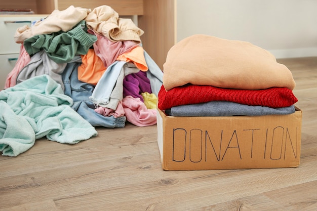 Donation box with warm clothes in the room