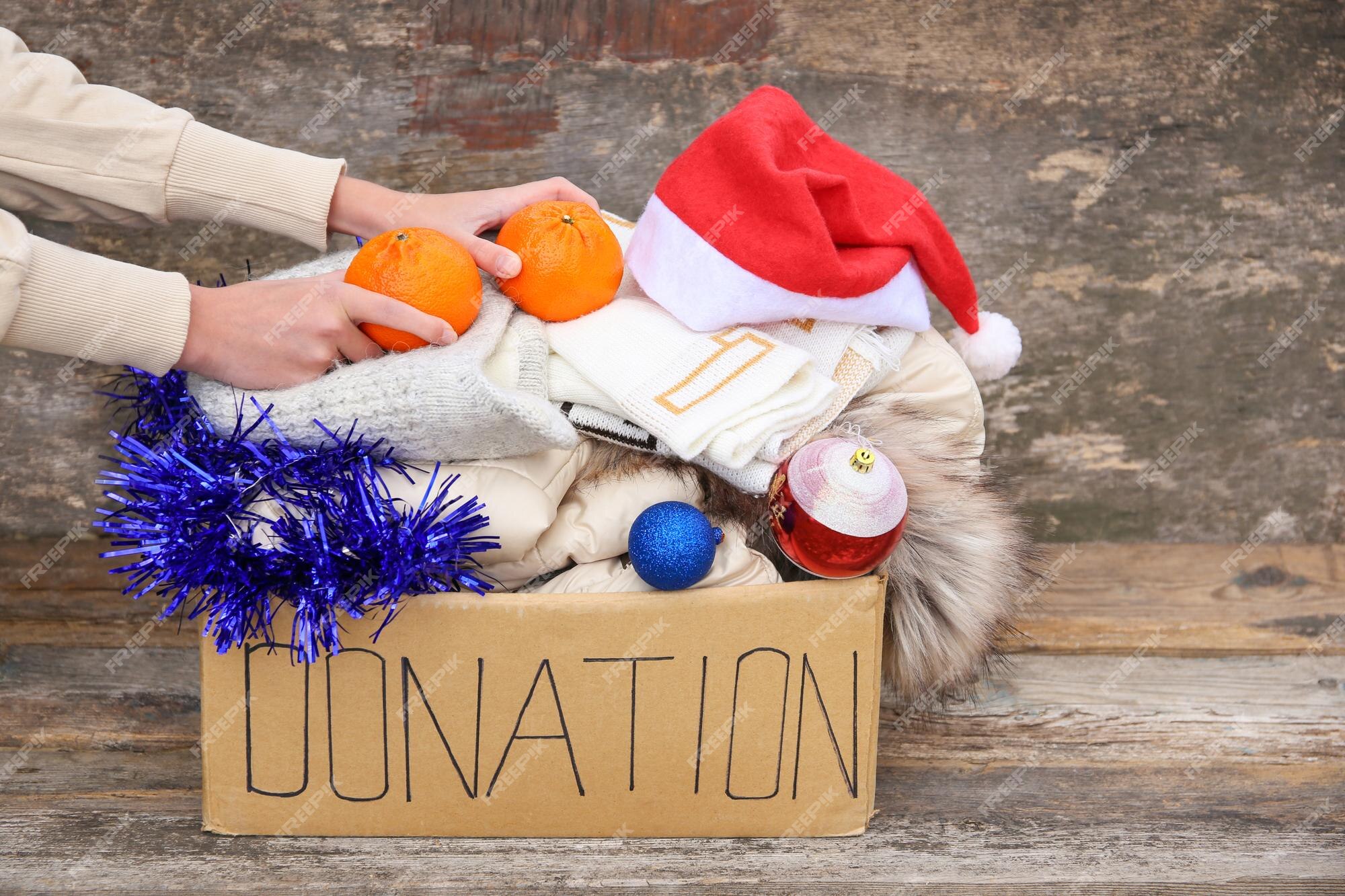 Premium Photo | Donation box with winter clothes and with ...